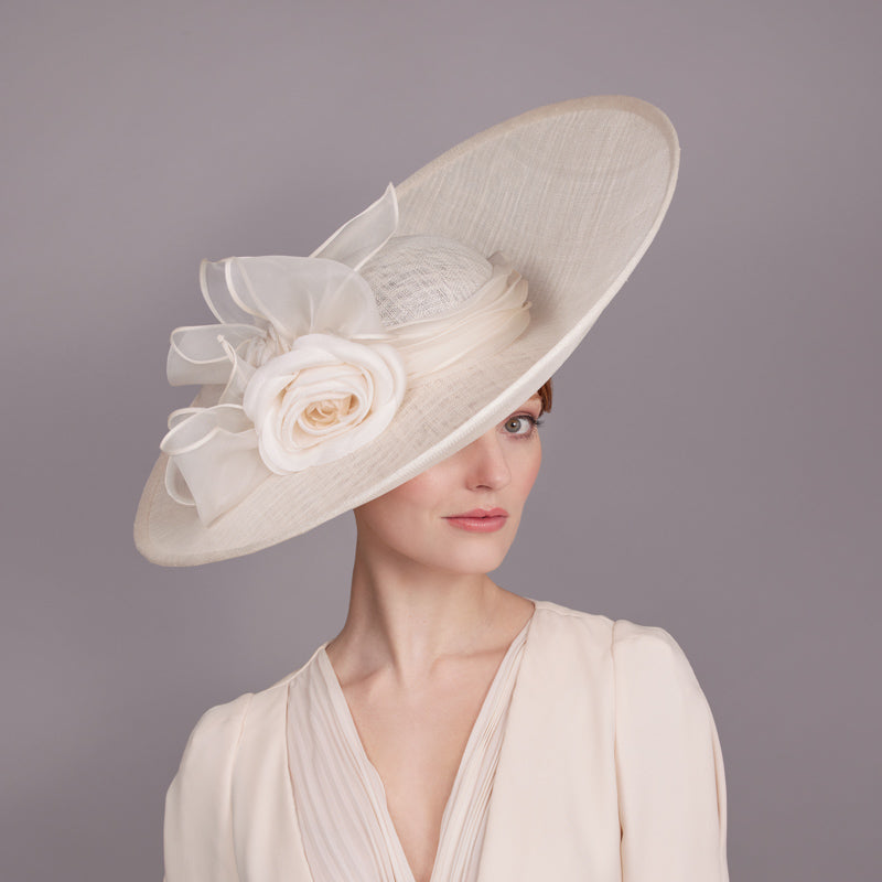 Ivory lame sidesweep with silk camellia and rolled bow
