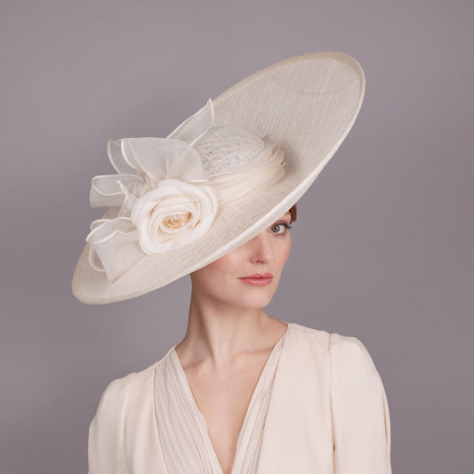 Ivory lame sidesweep with silk camellia and rolled bow